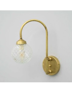 Arch-shaped metal structure in aged brass effect craftsman finish and a carved transparent glass ball 2