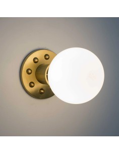 wall light with metal structure in brass color with studs with an LED bulb