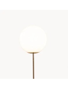 Vintage floor lamp with shiny gold metal stand and vintage white glass ball with vintage light