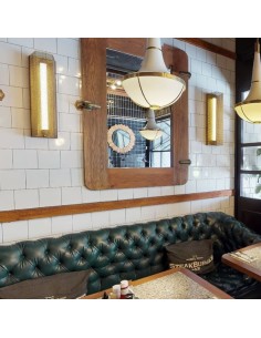 handcrafted finish in aged brass effect of perforated sheet metal that surrounds an LED light tube 2