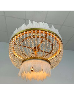 Fabien ceiling lamp with white feathers and crystals illuminated in pink