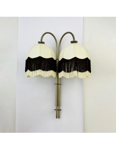 decorative wall light in aged brass with fringes