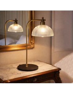 Elegant brass and glass table lamp next to mirror in classic bedroom