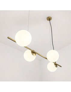 Close-up of a brass pendant lamp with opal glass spheres, featuring an elegant contemporary design.