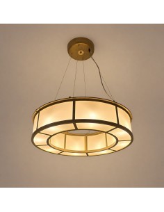 Close-up of the circular ceiling lamp with a brass frame and warm diffused light.
