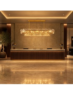 Close-up of the illuminated Florencia pendant light, featuring a gold structure and crystal details. 2