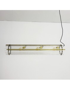Linear glass and brass pendant lamp with warm lighting. 2
