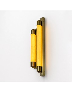 Vertical gold wall lights with warm lighting and an elegant design.