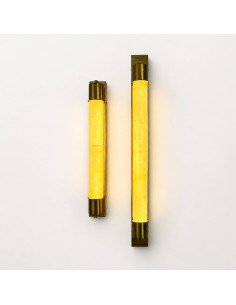 Vertical gold wall lights with warm lighting and an elegant design. 2