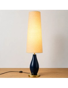 Floor lamp with a dark blue base and linen shade that brings warmth and elegance to the living room.